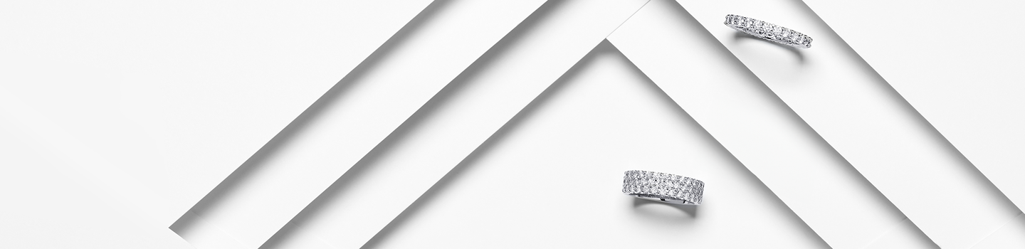 Birks diamond eternity rings on a white layered background.